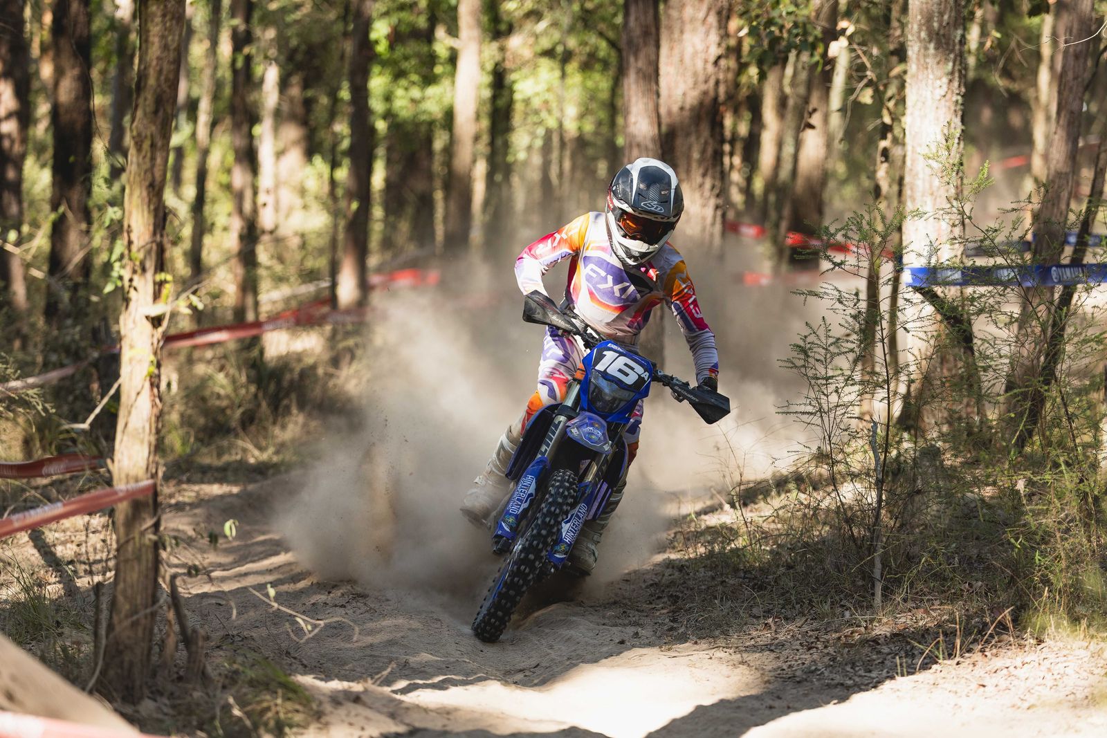 Deegan Graham racing through dust in the forest